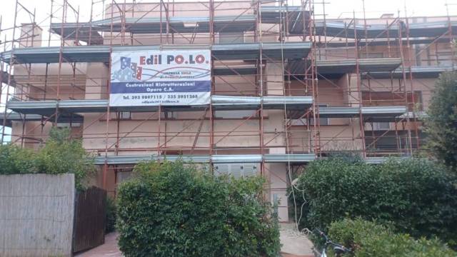Facciata di un condominio con ponteggio e cartello di cantiere Edil POLO
