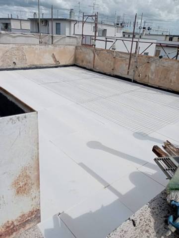 Posa di pannelli isolanti sul terrazzo di copertura di un edificio